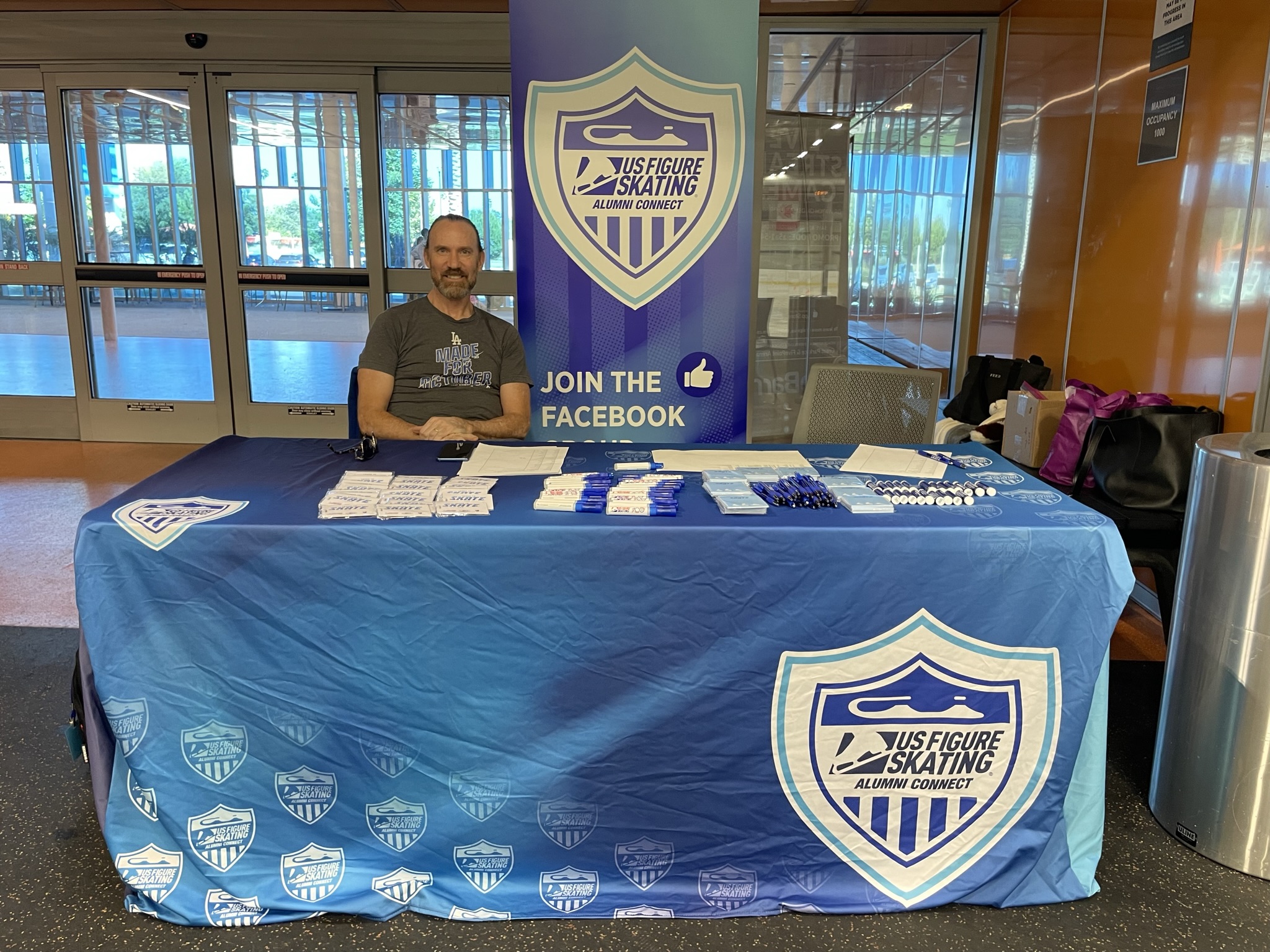 Doug Williams sits at the alumni connect check in table
