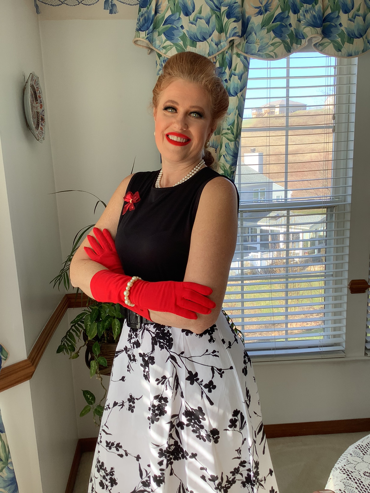 Cara Zanella in a polka dot dress and red gloves