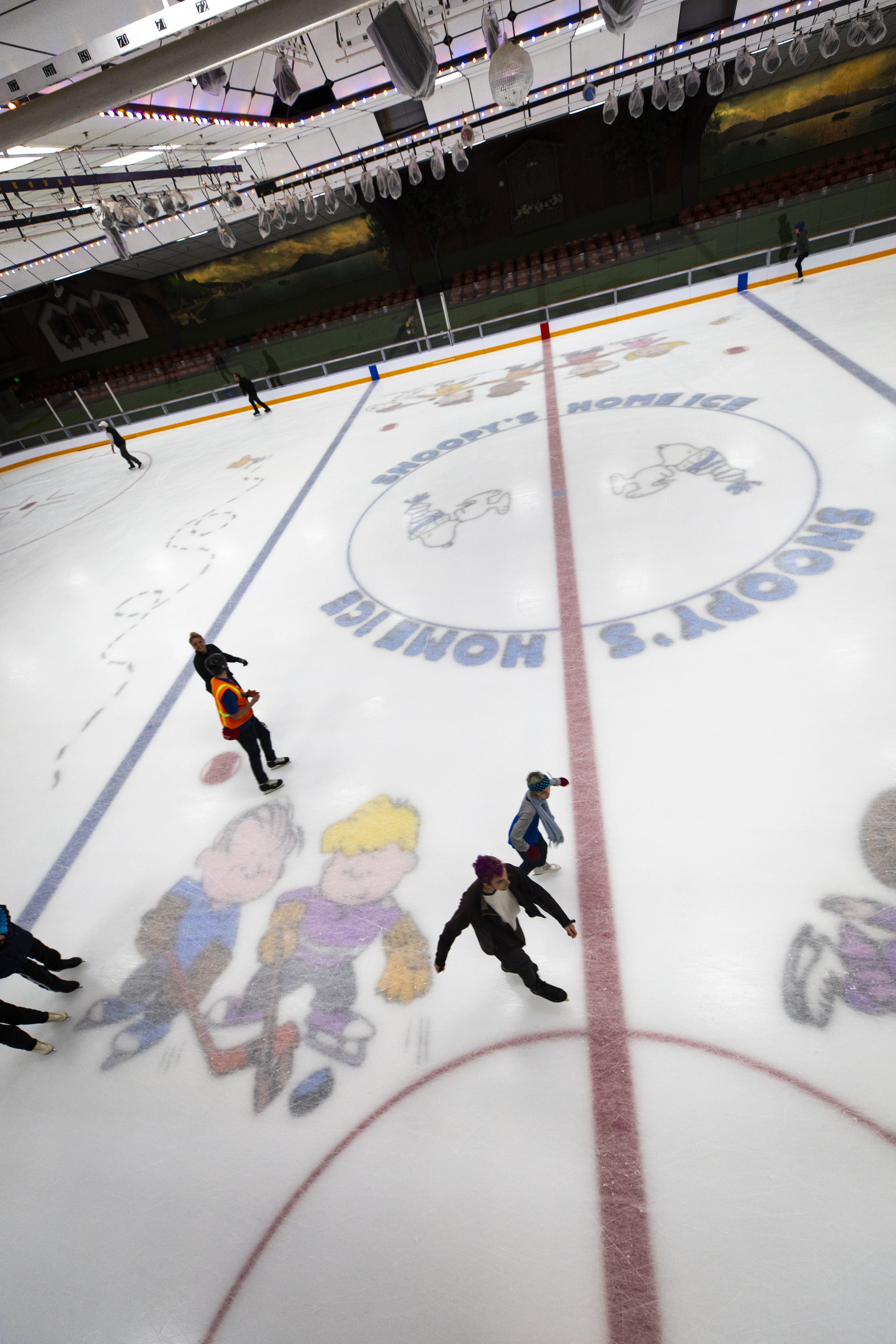 With an aerial view, skaters stroke around Snoopy's Home Ice.