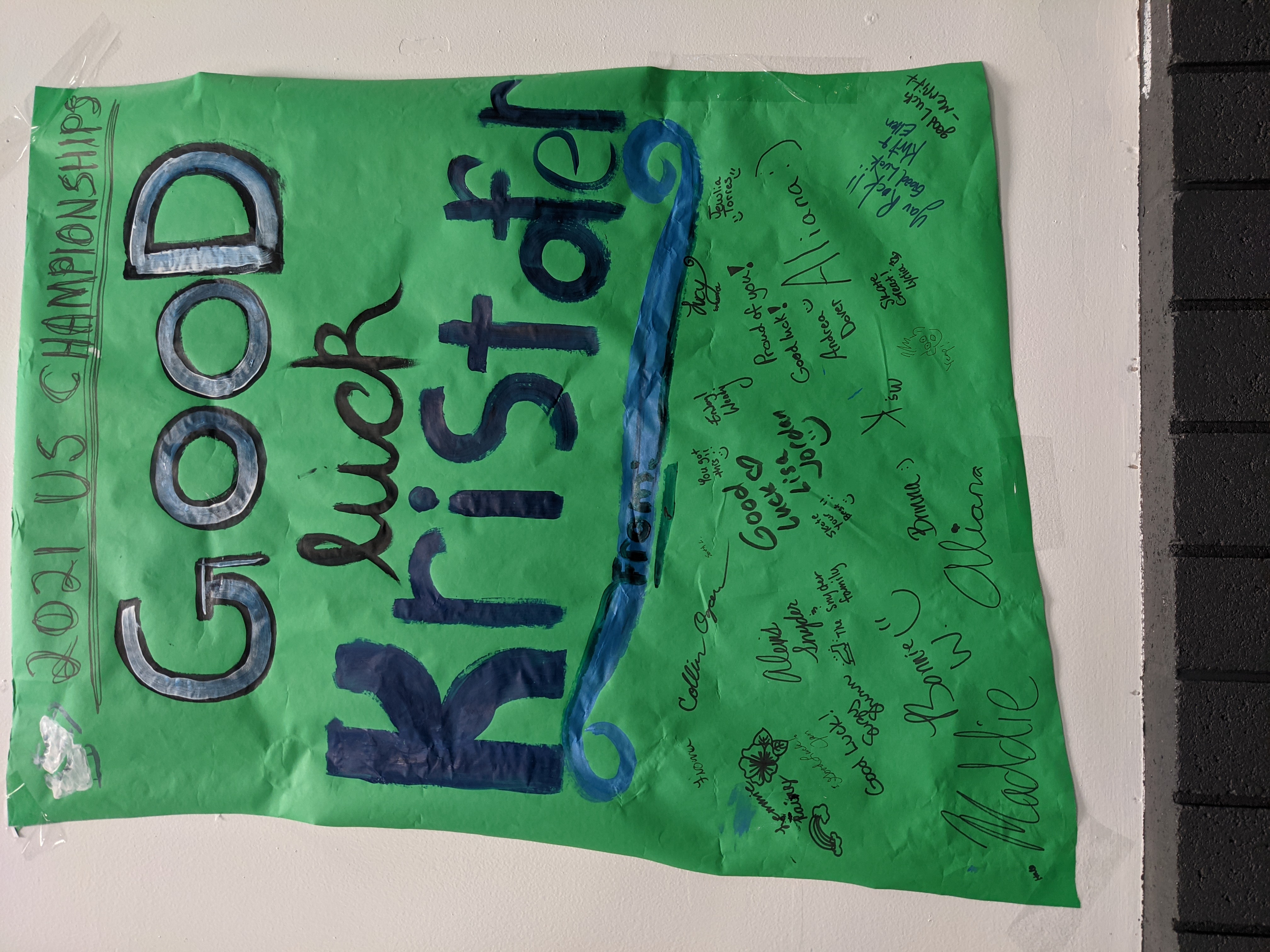 A green banner signed by Kristofer Ogren's club peers to wish him luck.