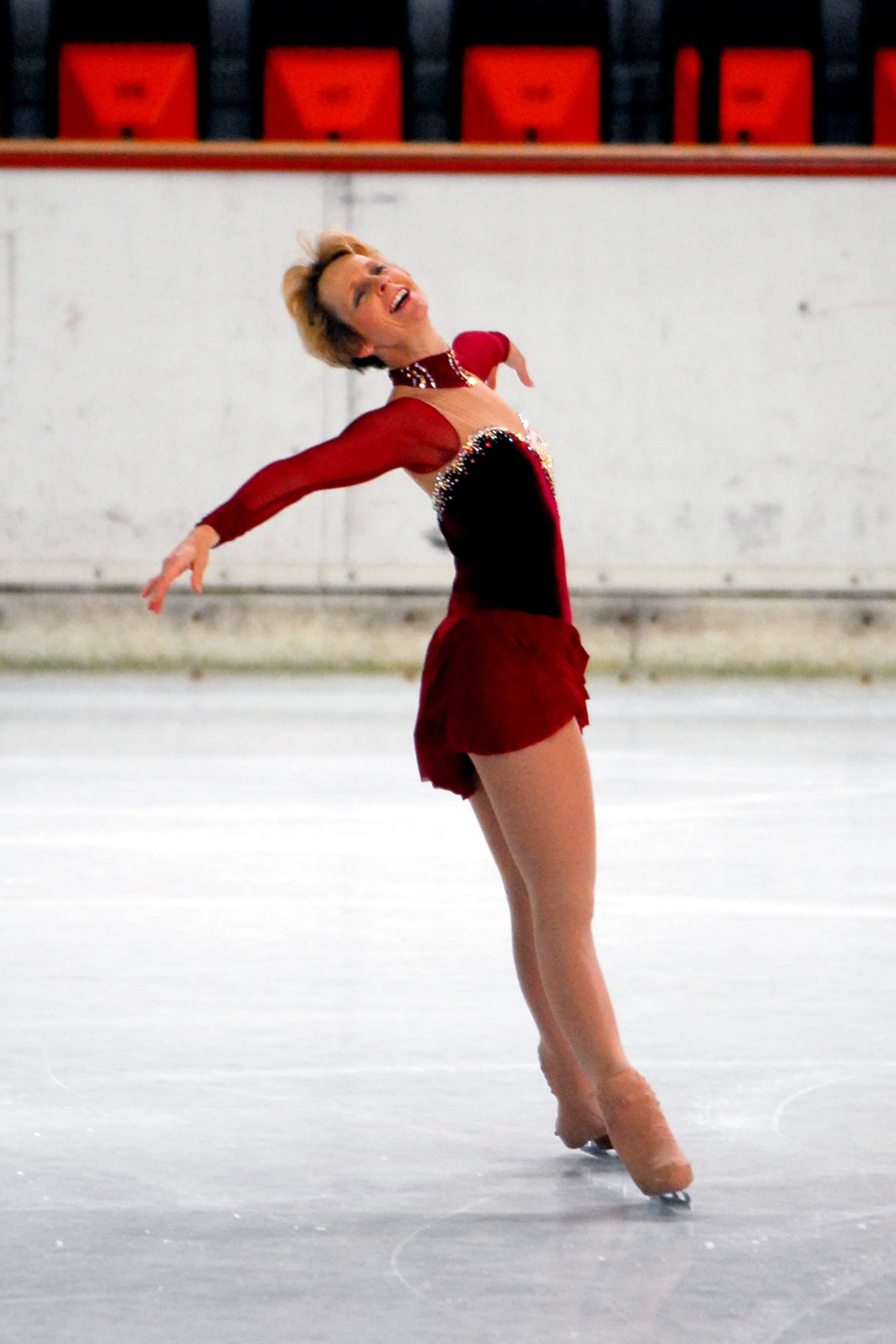 Paula Smart performs a spread eagle in a red dress. 