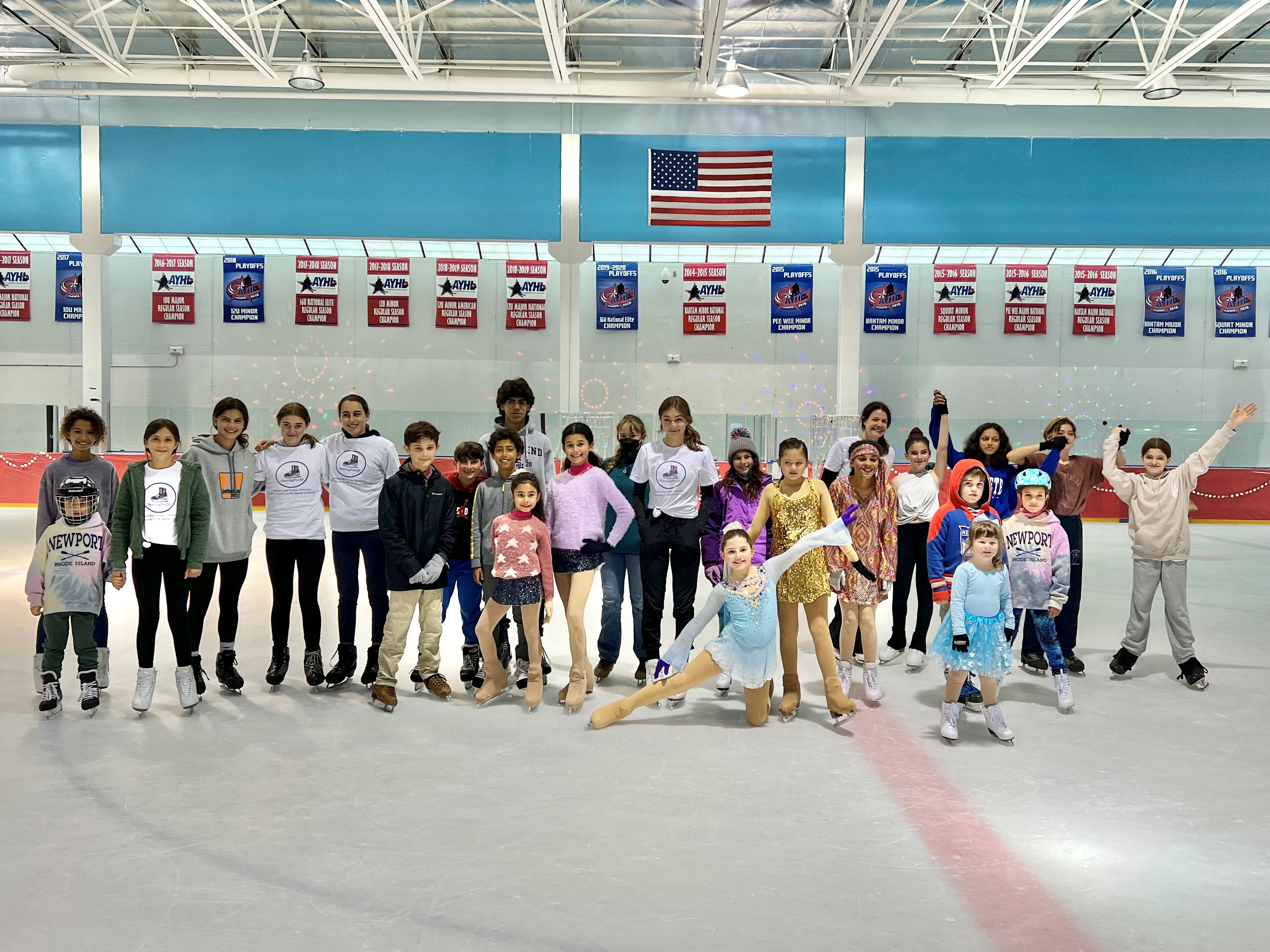 A group picture of various people on the ice.