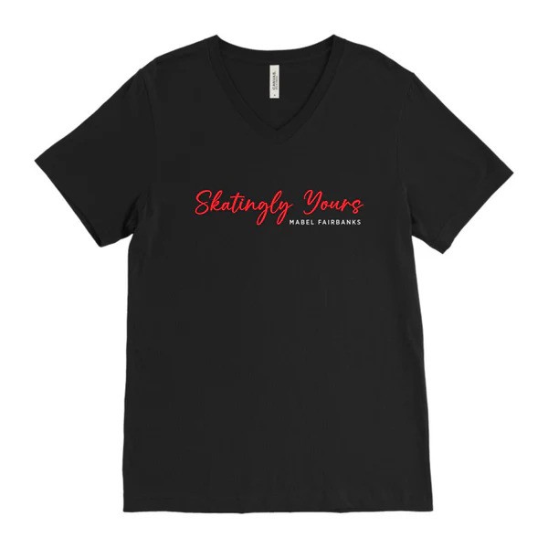 Image of a black tshirt that says Skatingly Yours in red and Mabel Fairbanks below it in white