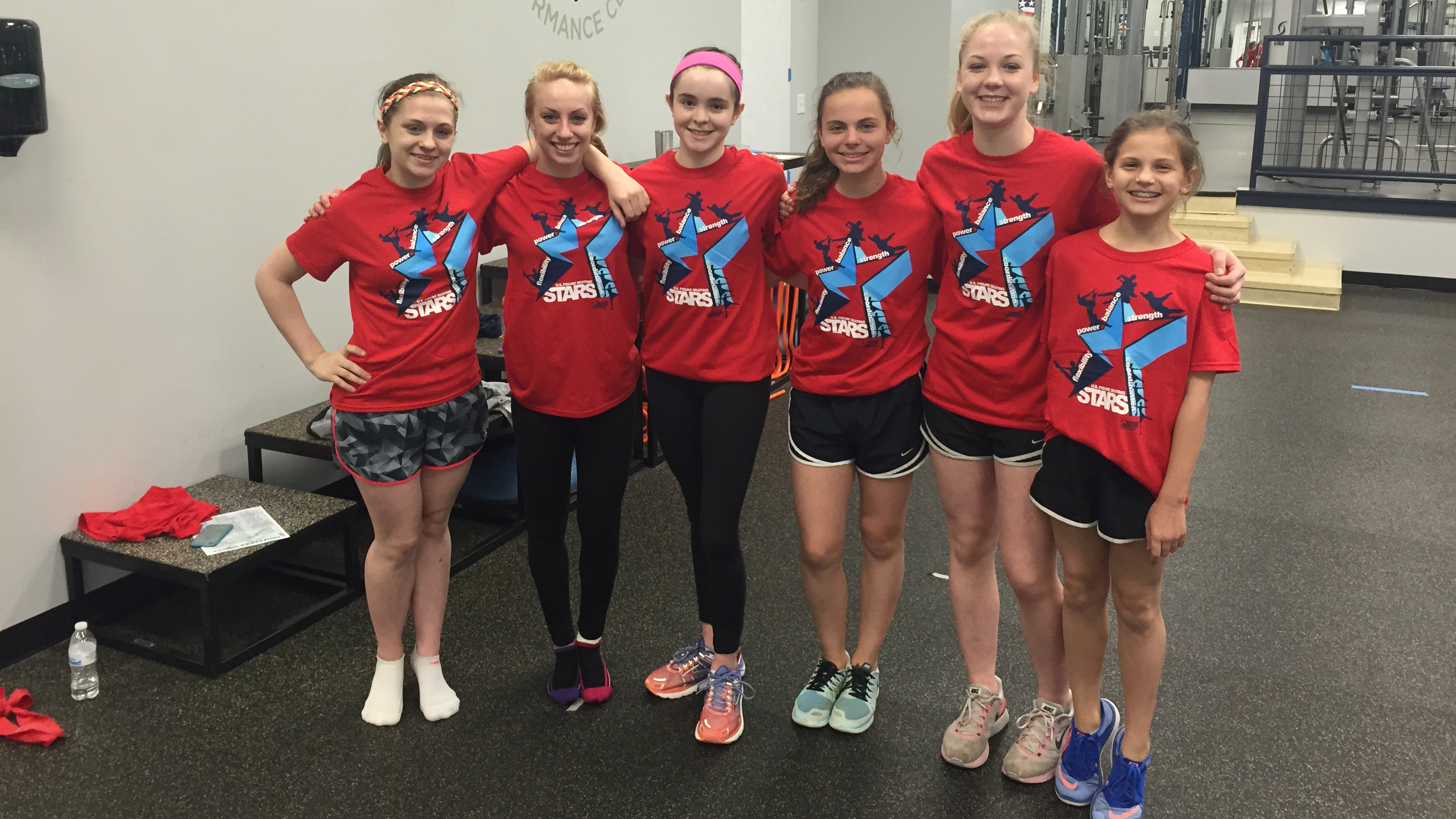A group of athletes in red shirts pose for a picture at a STARS combine