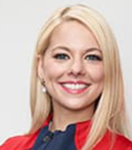 Headshot of Alexa Knierim. Alexa is a woman with long blonde hair wearing a blue and red Team USA jacket